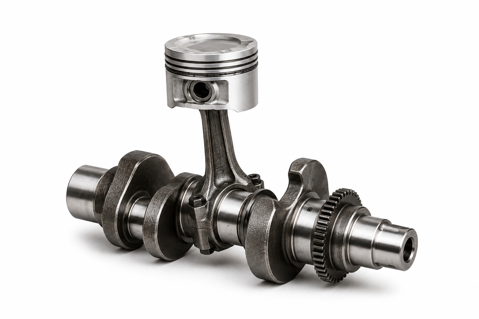 Forged steel crankshaft with a forged connecting rod and aluminium piston assembled on a crankpin, illustrating crankshaft failure analysis and internal combustion engine components.