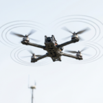 Modern counter-drone detection tower with radar panel, EO IR camera gimbal, and acoustic microphone array.